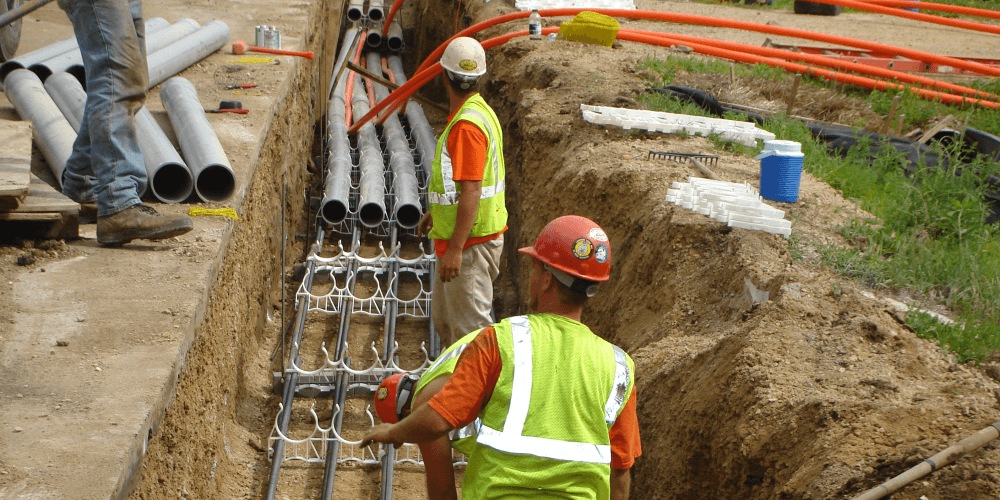 workers installing underground power lines
